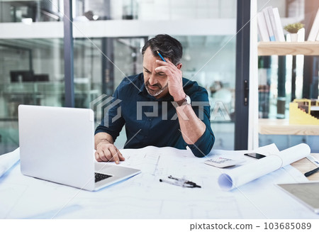 The internet will help me with inspiration. a mature male architect using his laptop. The internet will help me with inspiration. a mature male architect using his laptop. 103685089