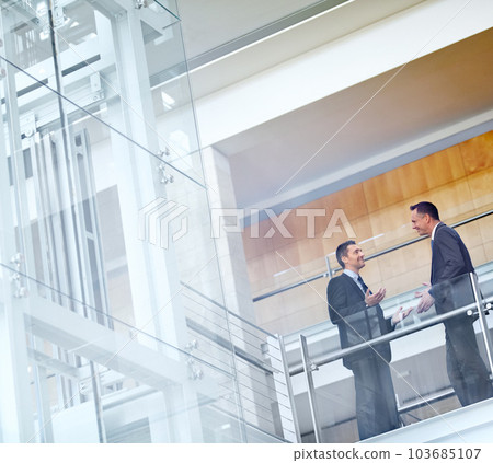 Business men, talking and networking with communication, meeting and collaboration on balcony at airport or office. Partnership, business meeting or travel with b2b, conference and corporate strategy 103685107