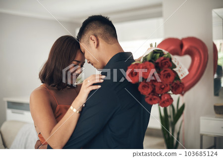 Love, roses and valentines day with a couple hugging in their home, in celebration of romance. Dating, flowering boquet or surprise with a man and woman in a house to hug while bonding in intimacy Love, roses and valentines day with a couple hugging in their home, in celebration of romance. Dating, flowering boquet or surprise with a man and woman in a house to hug while bonding in intimacy 103685124