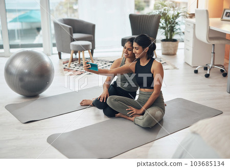 Exercise, fitness selfie and women together at home for social media memory or post. Indian sisters or female friends in lounge with a photo for influencer update, workout motivation or happy results 103685134