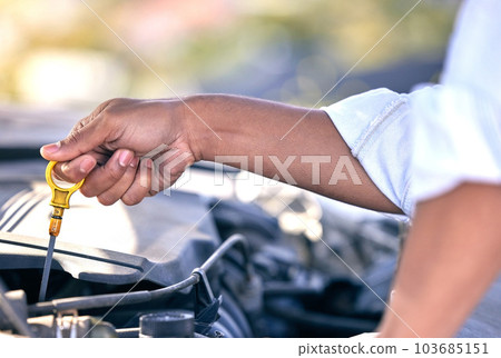 Maybe its the oil. Cropped shot of an unrecognizable man checking under the hood of his car after suffering a vehicle breakdown. 103685151