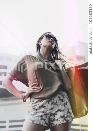Shopping bag, city woman and confidence for fashion style trend, luxury store present or buying designer brand clothes. Pride, fashionable and female customer satisfaction for commerce retail spree 103685329