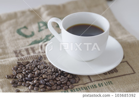 coffee beans and mug of coffee coffee beans and mug of coffee 103685392