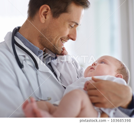 Happy male doctor, pediatrician and holding baby for hospital assessment, medical support and growth. Pediatrics, physician and carrying newborn kid in clinic, healthcare service and helping children Happy male doctor, pediatrician and holding baby for hospital assessment, medical support and growth. Pediatrics, physician and carrying newborn kid in clinic, healthcare service and helping children 103685398