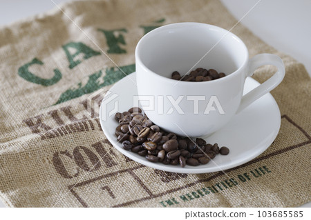 Coffee beans and mugs Coffee beans and mugs 103685585