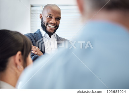 He loves hearing all the positive feedback from his team. Shot of a young businessman having a meeting with his colleagues in an office. He loves hearing all the positive feedback from his team. Shot of a young businessman having a meeting with his colleagues in an office. 103685924