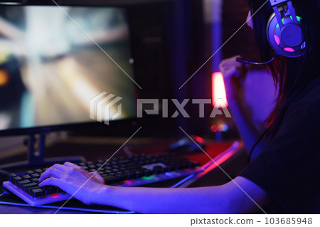 Female cyber hacker gamer watching monitor and making win gesture after hacking video games success Female cyber hacker gamer watching monitor and making win gesture after hacking video games success 103685948