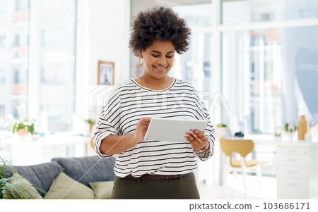 There are many smart ways to handle business. a young businesswoman using a digital tablet in an office. 103686171