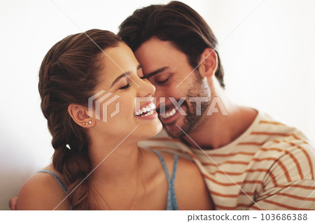 Our love only grows my the day. an affectionate young couple bonding at home. 103686388