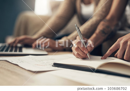 Stay organised, stay out of debt. a couple going over paperwork at home. Stay organised, stay out of debt. a couple going over paperwork at home. 103686702