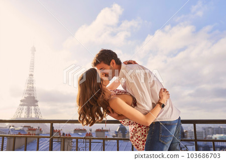 Paris, love and couple together for a kiss, romantic time or balcony of apartment, hotel with Eiffel Tower in background. Partner, woman and man in France for vacation, travel or honeymoon holiday Paris, love and couple together for a kiss, romantic time or balcony of apartment, hotel with Eiffel Tower in background. Partner, woman and man in France for vacation, travel or honeymoon holiday 103686703