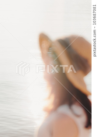 A woman standing at sunset A woman standing at sunset 103687081