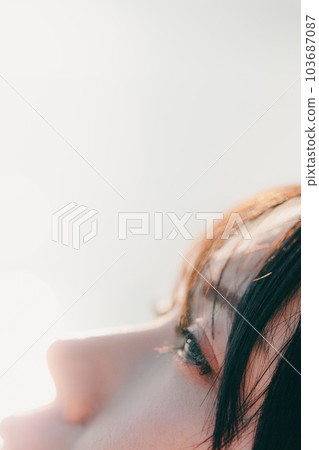 A woman standing at sunset A woman standing at sunset 103687087