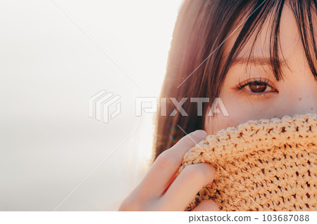 A woman standing at sunset 103687088