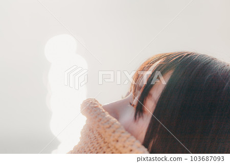 A woman standing at sunset 103687093