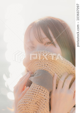 A woman standing at sunset A woman standing at sunset 103687097