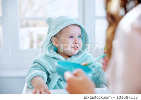 My first meal for the day. Shot of a baby being fed at home. 103687118