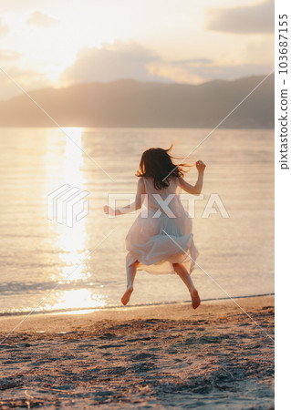 woman jumping on the beach 103687155