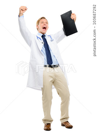 I knew you could overcome your condition. Full length shot of a handsome young doctor standing alone in the studio and holding a clipboard while celebrating. 103687292