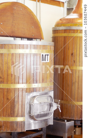 Brewery, machine and barrel for beer, alcohol and brewing process with a tap. Wooden, drum and alcoholic beverage at a distillery for storage, fermentation and manufacturing, industry or system Brewery, machine and barrel for beer, alcohol and brewing process with a tap. Wooden, drum and alcoholic beverage at a distillery for storage, fermentation and manufacturing, industry or system 103687449