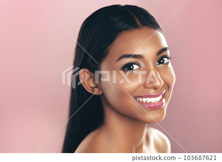 Shes a special kind of beautiful. Studio portrait of a beautiful young woman posing against a pink background. 103687621