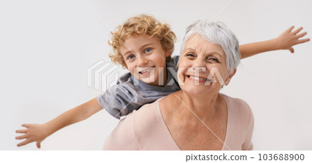 Airplane, smile and portrait of grandmother with child embrace, happy and bond on wall background. Love, face and senior woman with grandchild having fun playing, piggyback and enjoying game together 103688900