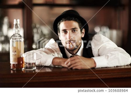 Bartender man, portrait and smoke cigarette at party, club or event with bottle for drink service. Male server, barman or waiter with glass, alcohol or whiskey to relax after work at restaurant job Bartender man, portrait and smoke cigarette at party, club or event with bottle for drink service. Male server, barman or waiter with glass, alcohol or whiskey to relax after work at restaurant job 103688984