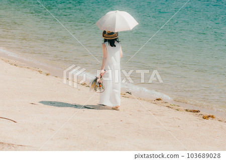 A woman holding a parasol and holding dried flowers 103689028