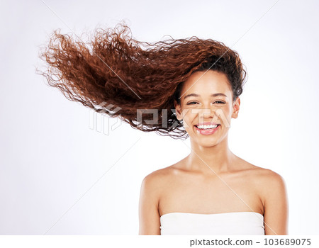 So shiny you almost wont believe it. Portrait of a young woman with flowing curls posing against a white background. So shiny you almost wont believe it. Portrait of a young woman with flowing curls posing against a white background. 103689075