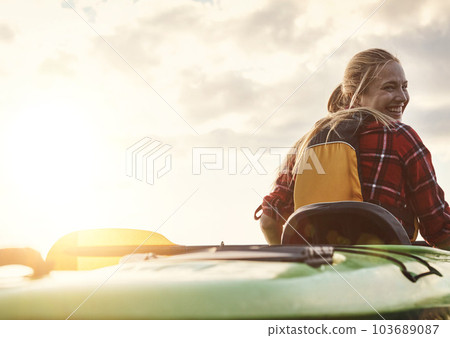 Canoeing is an exhilarating experience. an attractive young woman out for canoe ride on the lake. 103689087