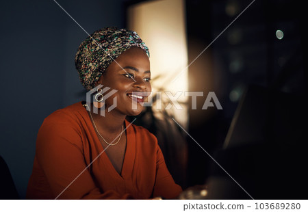 She stayed the night to work on her goals. a young businesswoman working in an office at night. 103689280