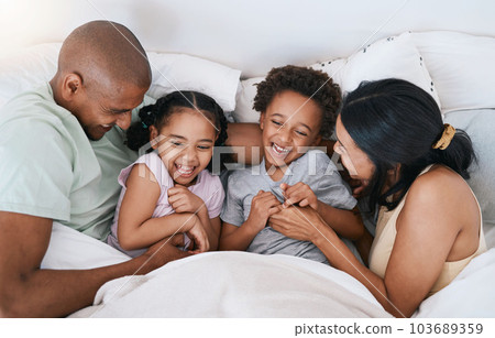 Happy family, relax and playing in bed above with smile in free time, weekend or fun holiday morning at home. Mother, father and children relaxing and laughing together for playful joy in the bedroom 103689359