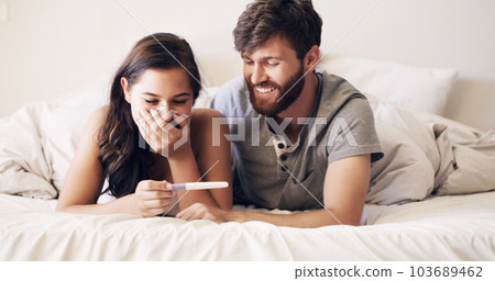 Couple, bedroom and pregnancy test, happy and excited for future family, life, love and happiness together. Positive results, man with pregnant woman on bed with good news, surprise and shock in home 103689462