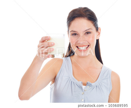 Portrait smile, woman and glass of milk for vitamin D healthcare benefits, bone health or nutritionist hydration drink. Calcium dairy product, wellness and studio model isolated on white background 103689595