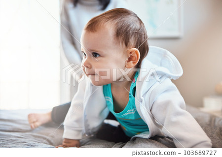 The age of curiosity. an adorable baby girl playing on the bed at home. 103689727