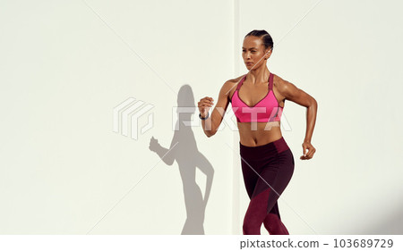 Woman, fitness and running on mockup for exercise, workout or healthy cardio training outdoors. Fit, active and sporty female person or runner exercising for health and wellness on mock up space 103689729