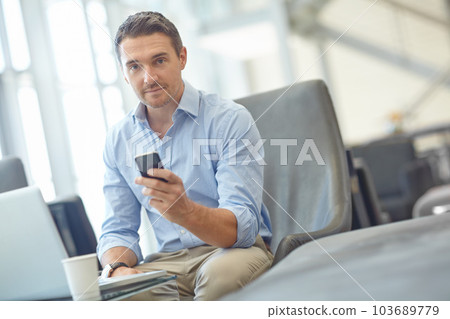 Business man portrait, travel or corporate with laptop for invest strategy, finance growth or financial review. CEO, airport or manager on smartphone for planning, data analysis or economy research 103689779