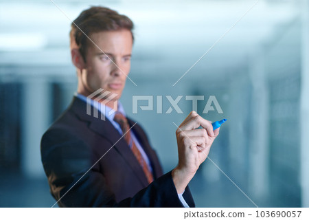 Ready to pen down his business plan. a handsome young business professional writing on glass with a marker. Ready to pen down his business plan. a handsome young business professional writing on glass with a marker. 103690057