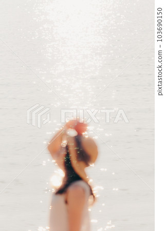woman with an apple on the beach 103690150