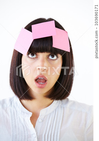 Confused, planning and woman brainstorming in studio with a shock, surprise or thinking face expression. Idea, contemplating and female model with paper notes on her head isolated by white background 103690171