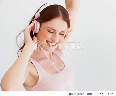 Happy woman, dance and headphones in white background, isolated studio and freedom of celebration, good mood and energy. Excited female model, dancing and listening to music, audio and radio sound Happy woman, dance and headphones in white background, isolated studio and freedom of celebration, good mood and energy. Excited female model, dancing and listening to music, audio and radio sound 103690176