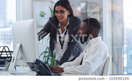 Black man, call center and woman with coach by computer, office or learning for tech support. African male crm, female mentor or teaching for telemarketing, training or customer service at help desk Black man, call center and woman with coach by computer, office or learning for tech support. African male crm, female mentor or teaching for telemarketing, training or customer service at help desk 103690184