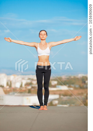 Calm woman, yoga and open arms on roof top in exercise, zen workout or fitness outdoors. Female yogi in warm up stretch or pose for healthy body, spiritual wellness or balanced mind outside town 103690609