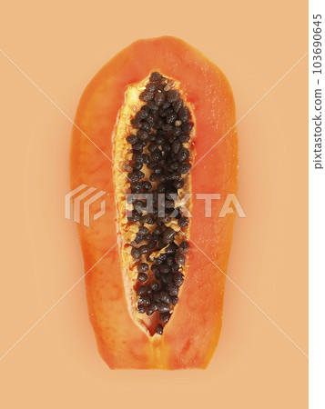 Half of ripe papaya fruit with seeds on a color background. Appetizing tropical fruit Half of ripe papaya fruit with seeds on a color background. Appetizing tropical fruit 103690645