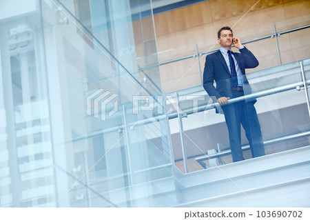 Corporate, travel or businessman on phone call for communication, networking or contact in office building. Company office, staircase or CEO with smartphone for discussion, speaking or conversation 103690702