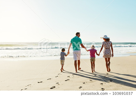 Summer days were made for the beach. a family enjoying some quality time together at the beach. 103691037