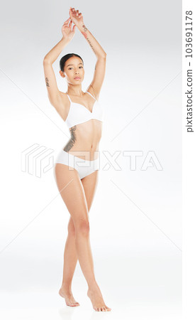 Natural beauty is the best beauty of the world. Shot of an attractive young woman posing in her underwear against a white background. Natural beauty is the best beauty of the world. Shot of an attractive young woman posing in her underwear against a white background. 103691178