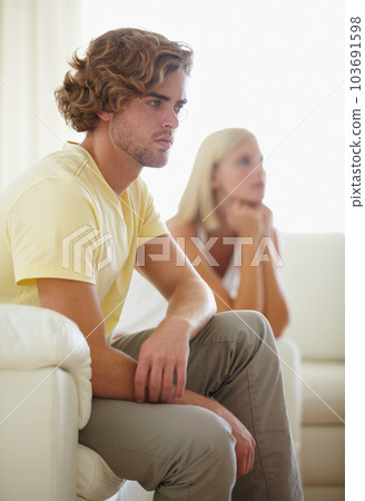 Regretting what he said. A young couple reflecting on a disagreement thats just taken place. 103691598