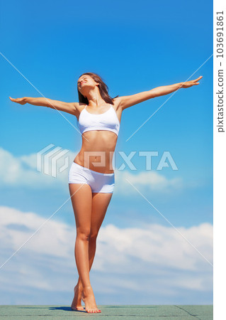 Blue sky, stretching arms and body of woman in underwear for fitness, freedom and achievement of health goals. Mockup, happiness and model on roof with sunshine space, healthy mindset and celebration Blue sky, stretching arms and body of woman in underwear for fitness, freedom and achievement of health goals. Mockup, happiness and model on roof with sunshine space, healthy mindset and celebration 103691861