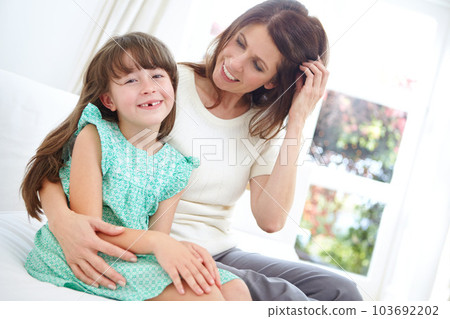 Theres no greater love. Portrait of a cute little girl spending time with her mother at home. 103692202